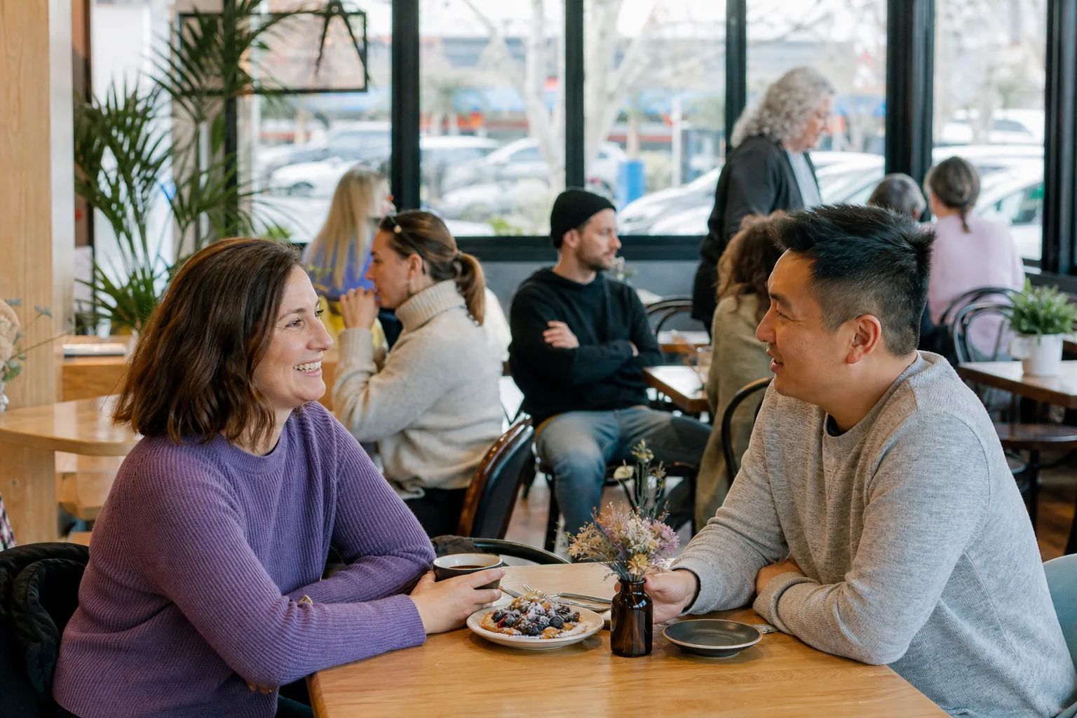 Two adults chatting over coffee in a Buckinghamshire town centre